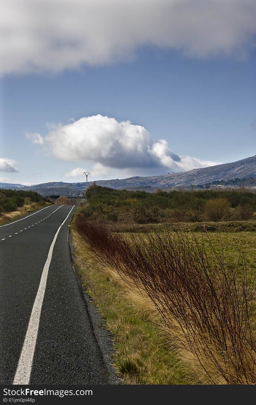 Road towards the mountains and the blue sky