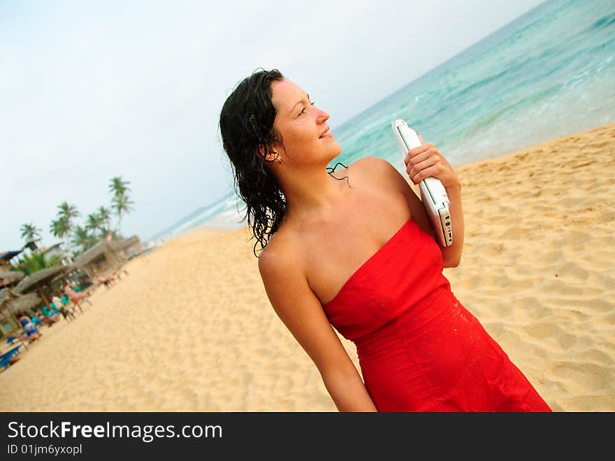 Beautiful Smiling Young Woman With Laptop On Beach