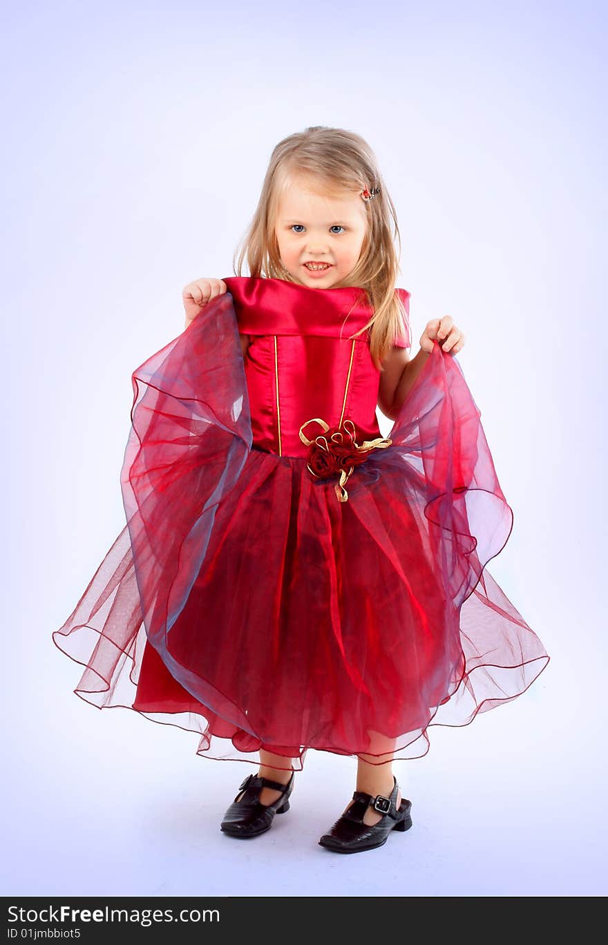 Portrait of the beautiful girl in a red dress