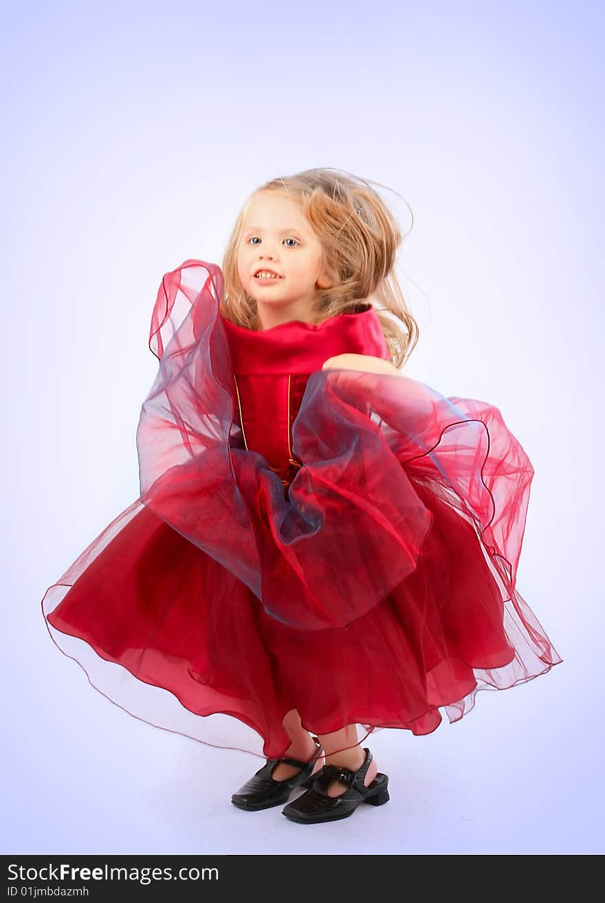 Portrait of the beautiful girl in a red dress