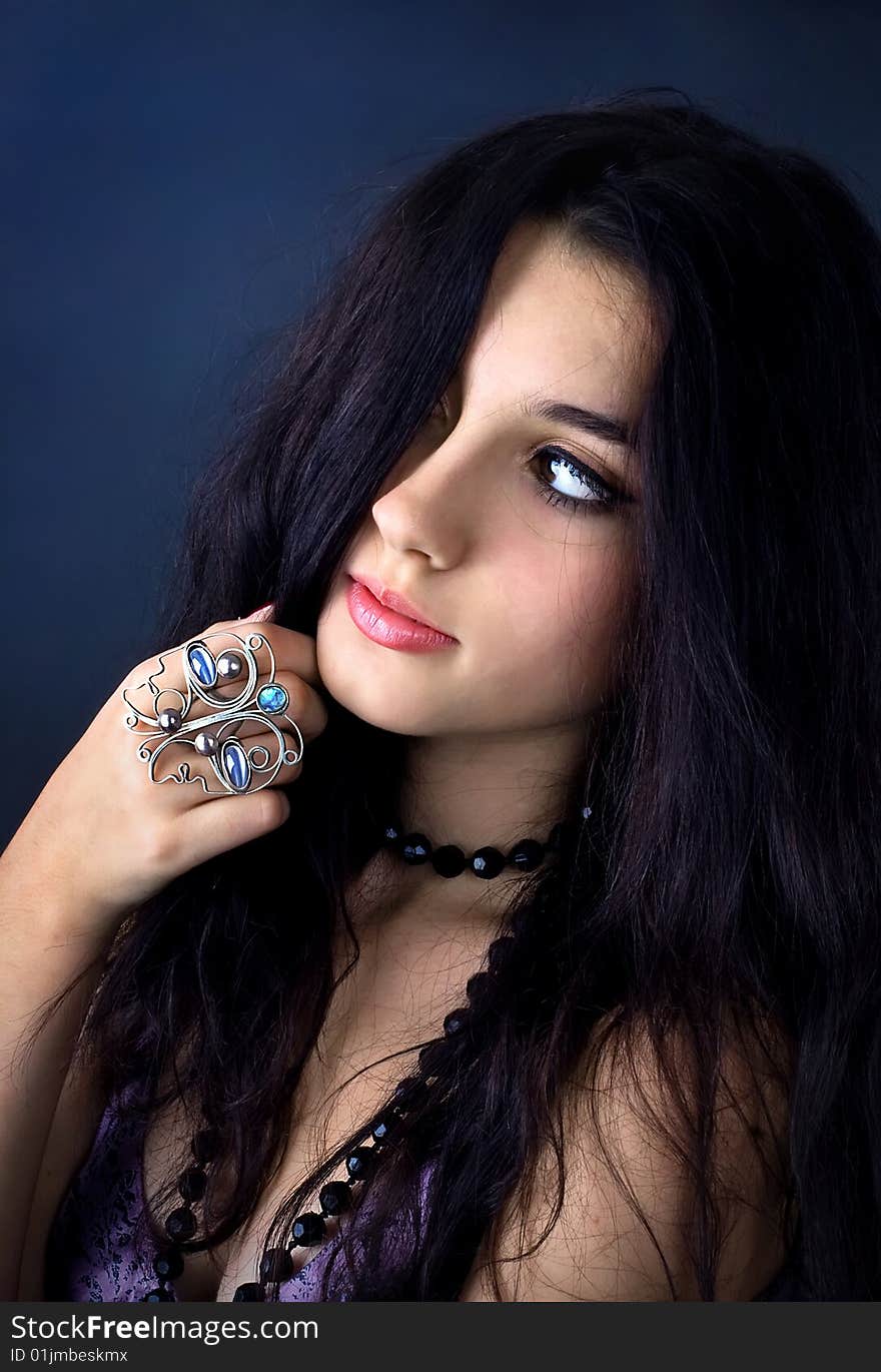 Series. Portrait of the beautiful brunette in a dark blue dress