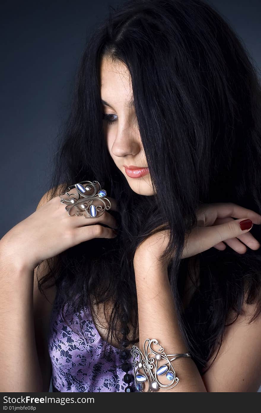 Series. Portrait of the beautiful brunette in a dark blue dress