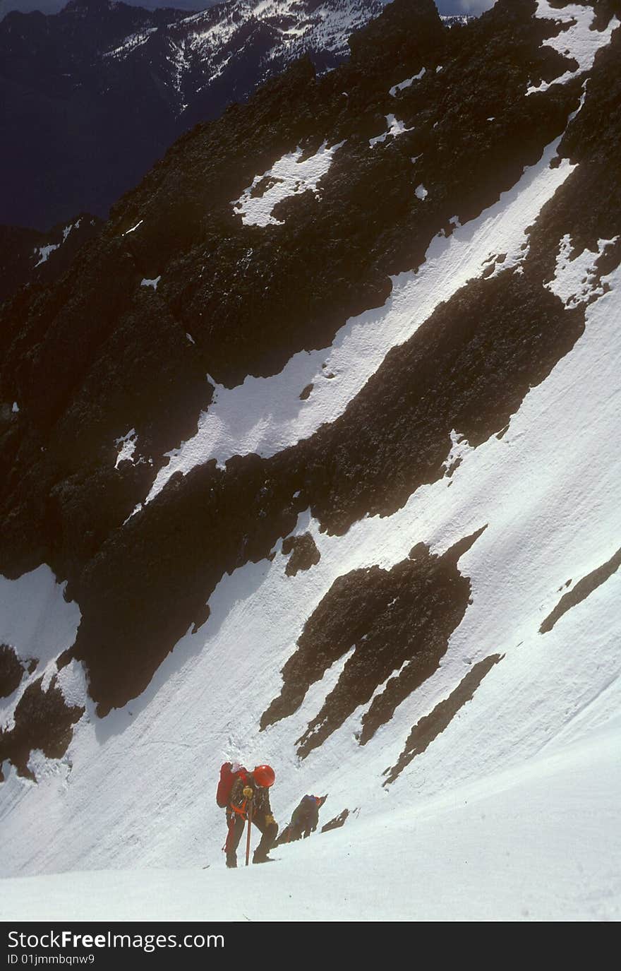 Climbers on steep snow face