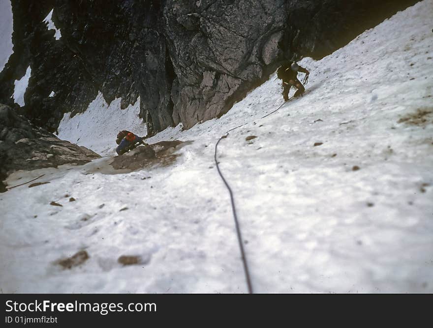 Climbers on steep snow face