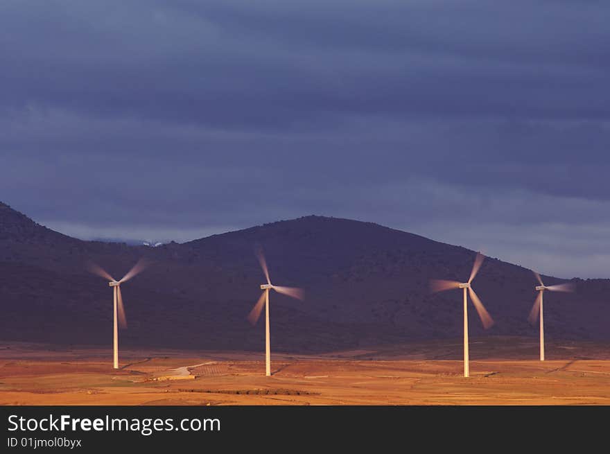 Windmills at dawn on a stormy