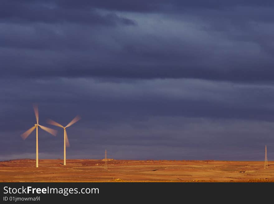 Windmills at dawn on a stormy