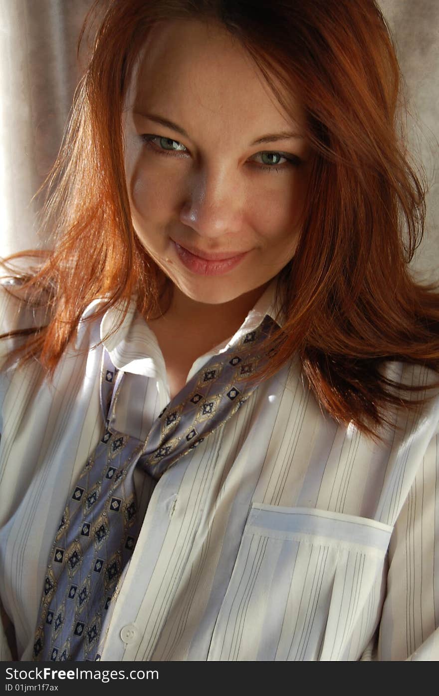 Young attractive brunette woman on  light background