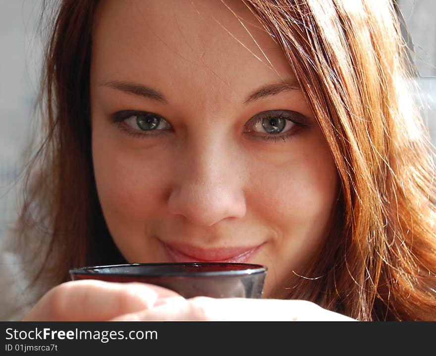 Woman, holding black cup in hands. Woman, holding black cup in hands