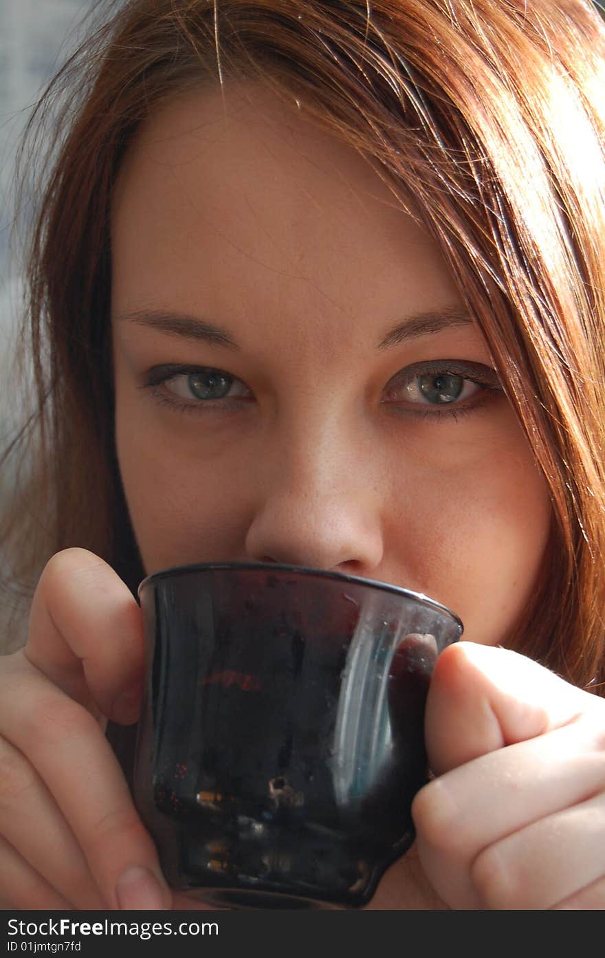 Woman drinking tea or coffee