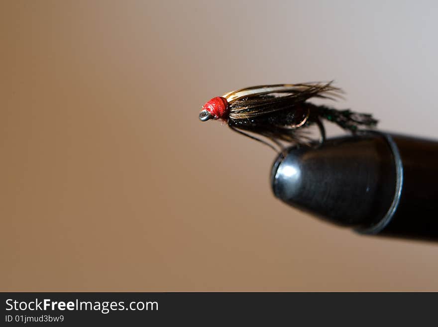 Fly fishing fly on the tying vise. Fly fishing fly on the tying vise