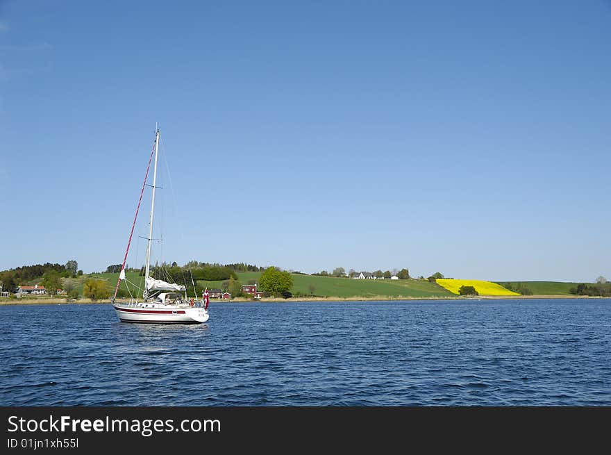 Saliboat at see with view to land. Saliboat at see with view to land