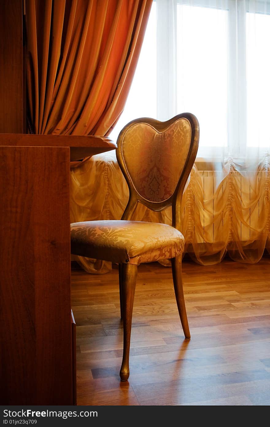 Table and chair by the window in a modern apartment