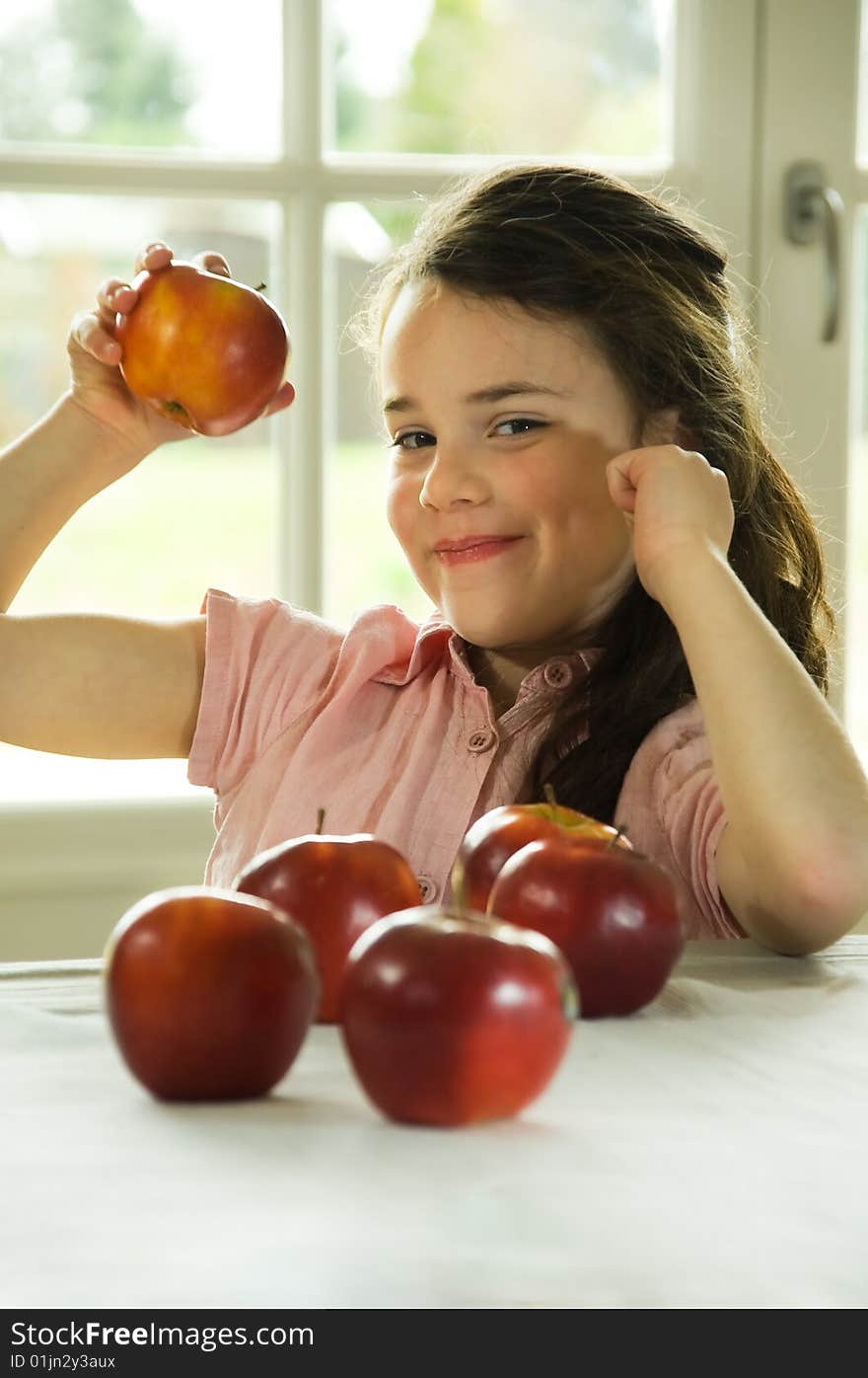 Brown Haired Child Presenting An Apple