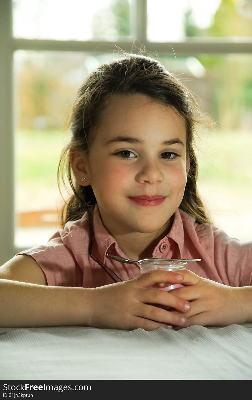 Brown Haired Child Eating Yogurt