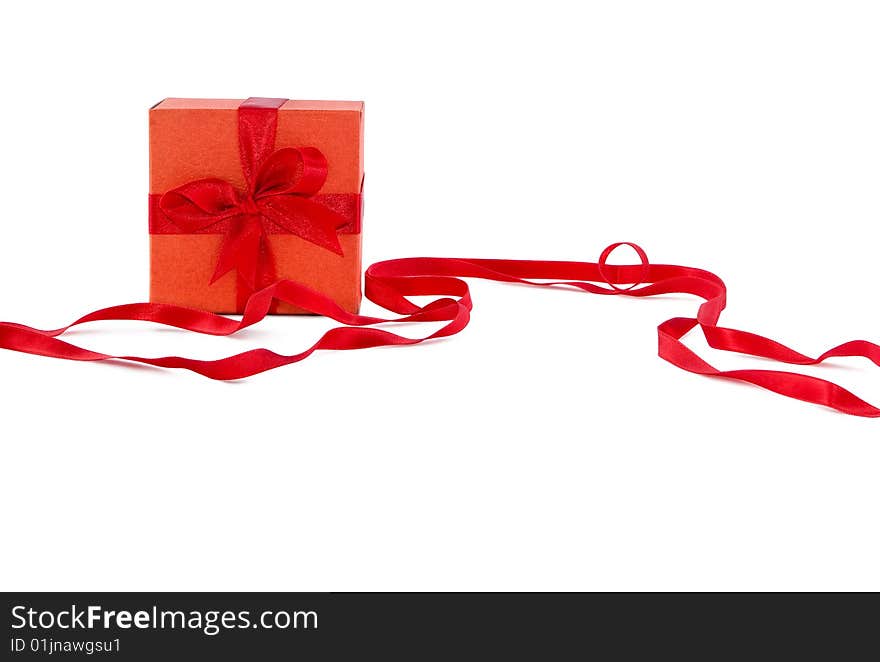 Orange box with red ribbon on white background