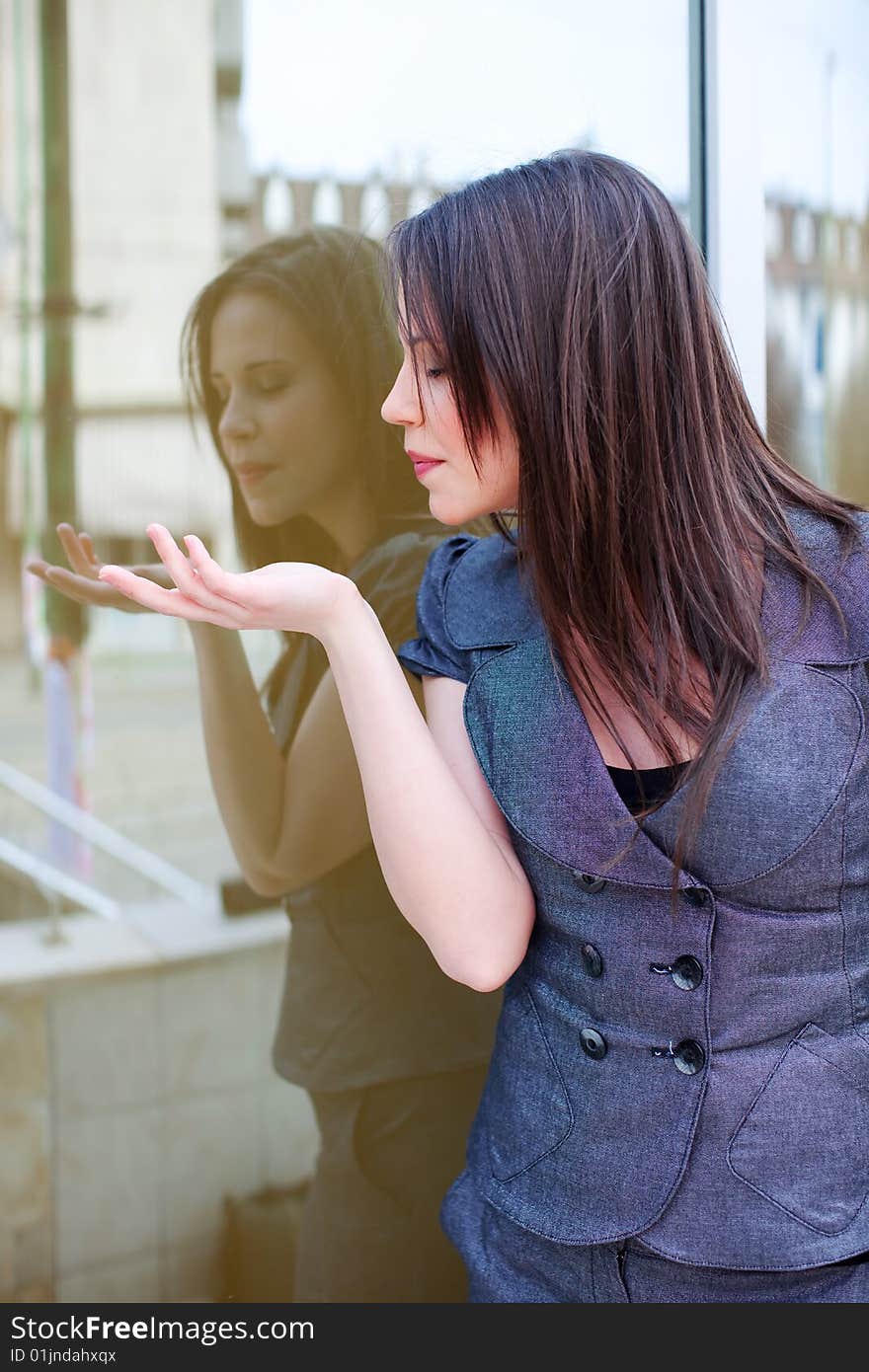 Portrait of a woman who is blowing off from a hand, blindly. Portrait of a woman who is blowing off from a hand, blindly