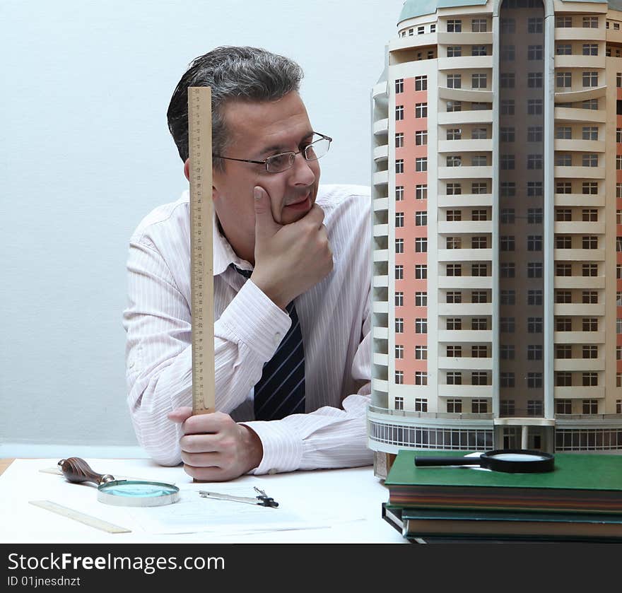 Architect with a breadboard model of a building