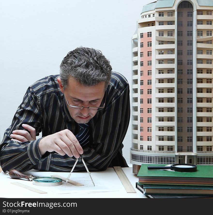 Architect with a breadboard model of a building