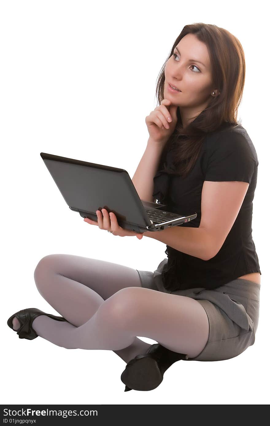 Thoughtful girl with the laptop isolated on a white background. Thoughtful girl with the laptop isolated on a white background