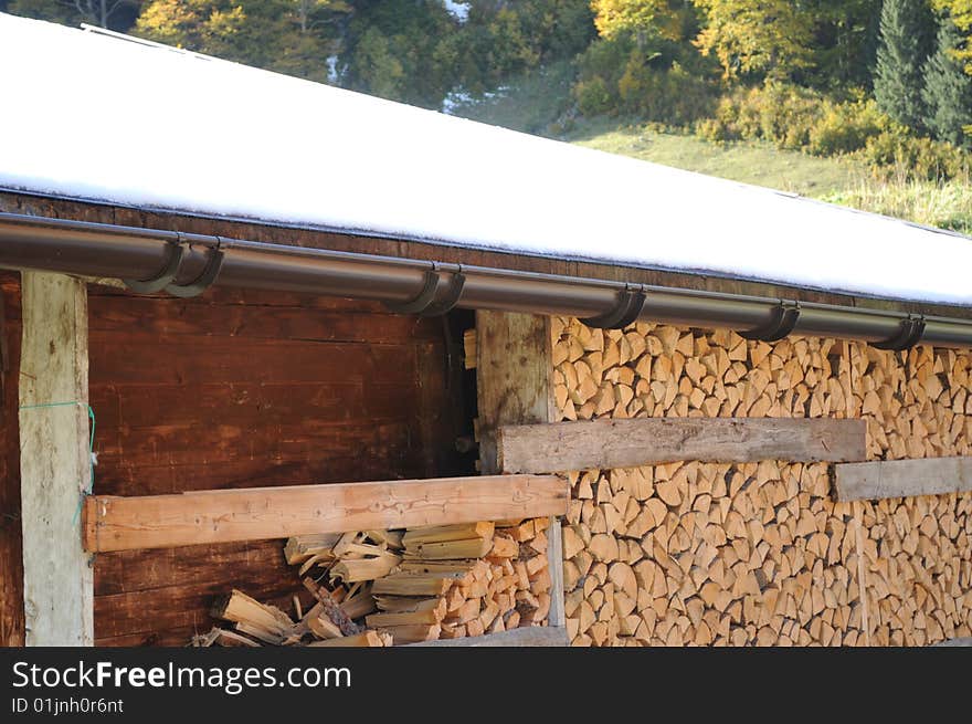 A depot of firewood in an alpine village. A depot of firewood in an alpine village.