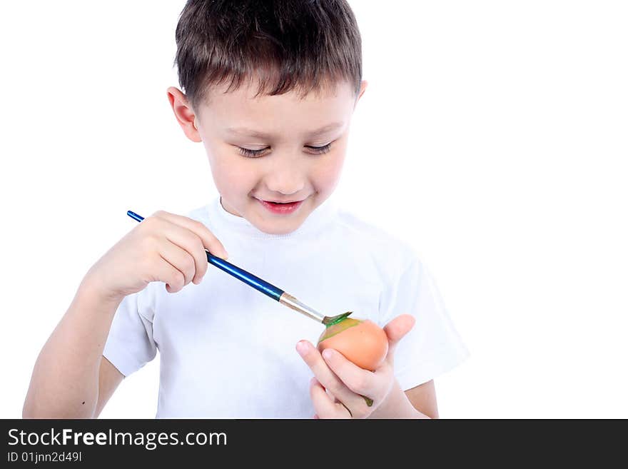 Little boy painting easter egg isolated on white