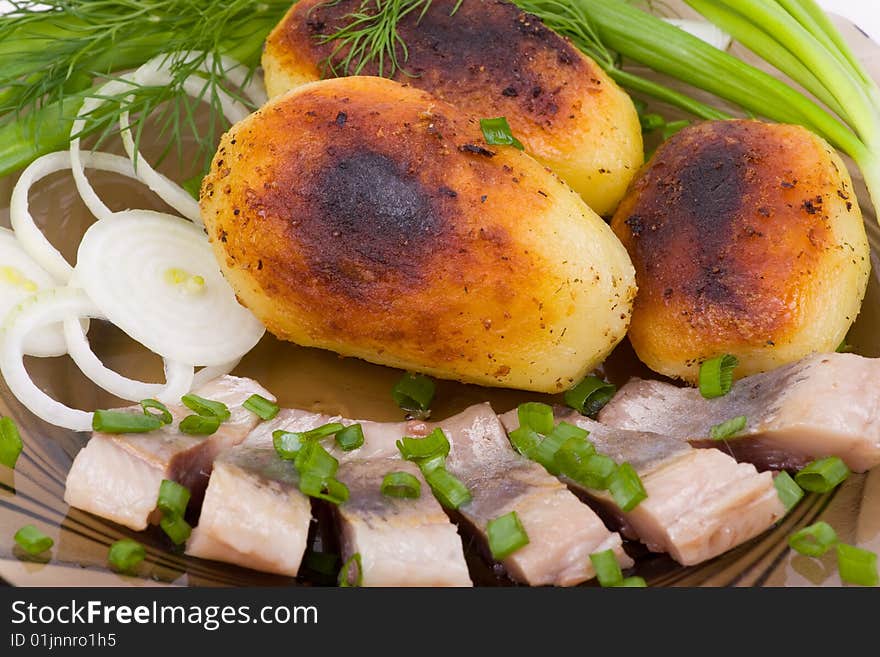 Baked potato with slices of a salty herring