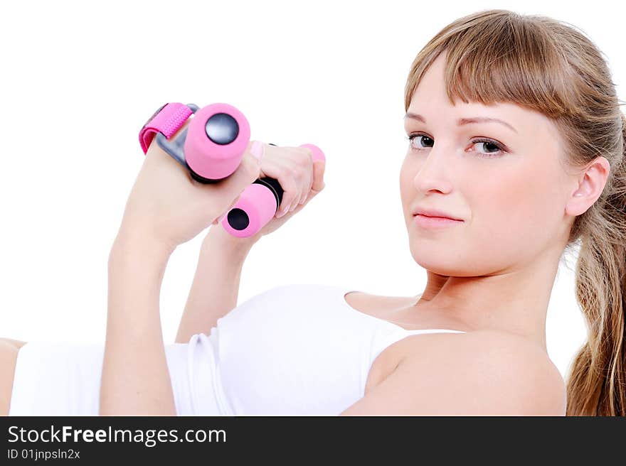 Portrait of young beautiful woman with dumbbells in her hands