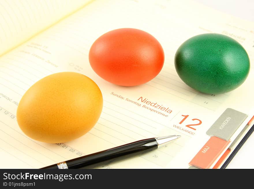 Colored, eggs, and business calendar plus calculator, pen and chart,. Colored, eggs, and business calendar plus calculator, pen and chart,