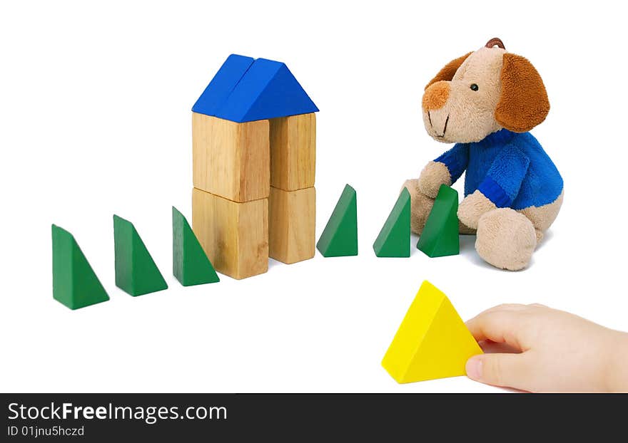 Wooden blocks and a toy on a white background. Wooden blocks and a toy on a white background