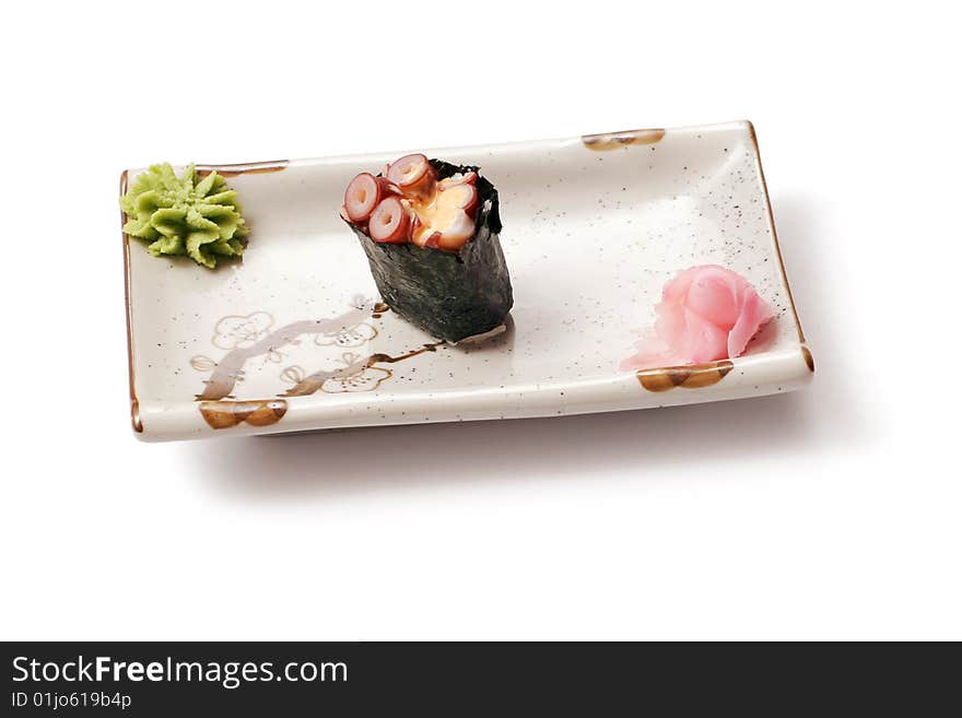 Sushi with octopus and ginger in white squared plate over white background