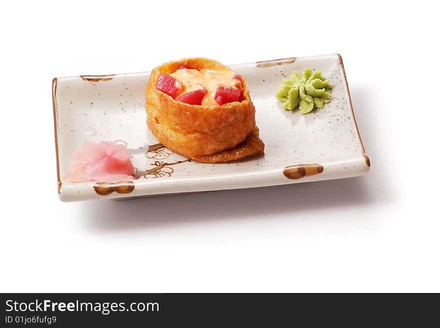 Sushi with tuna, cheese and ginger in white squared plate over white background