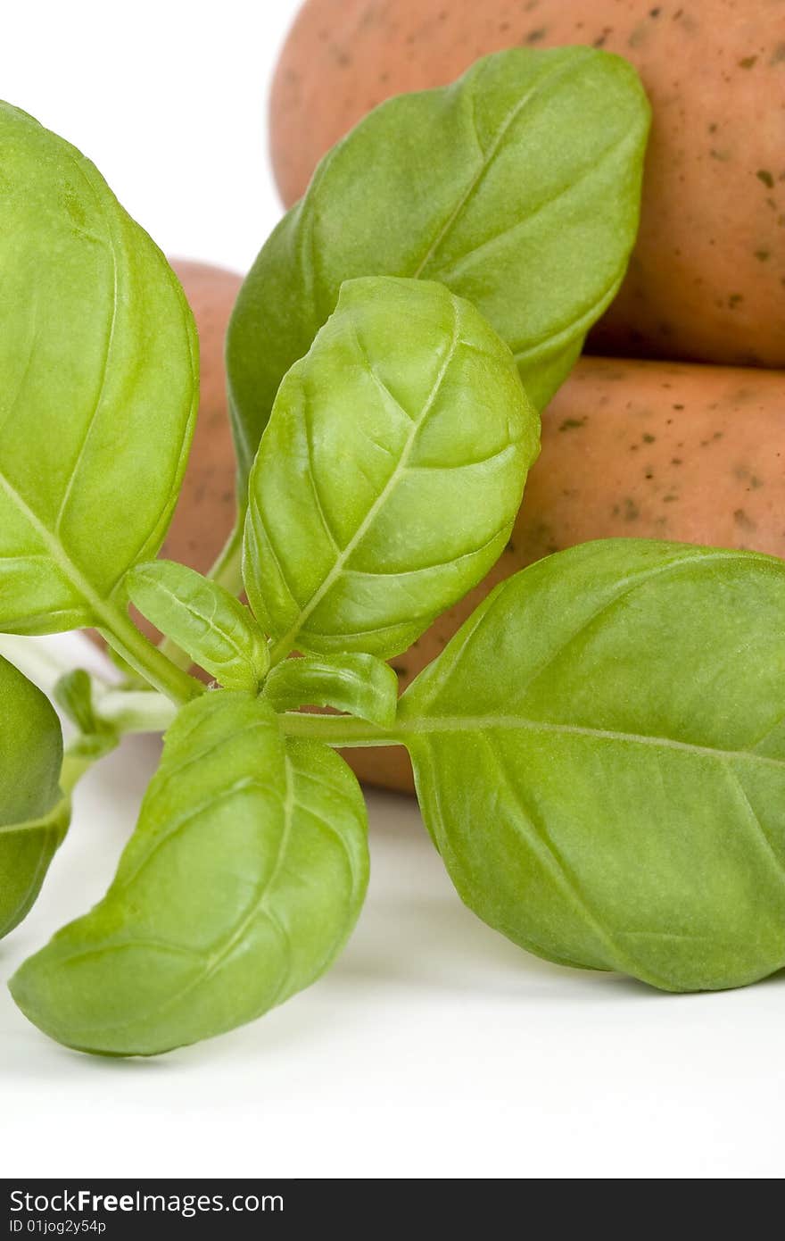 Detail of sausages with basil