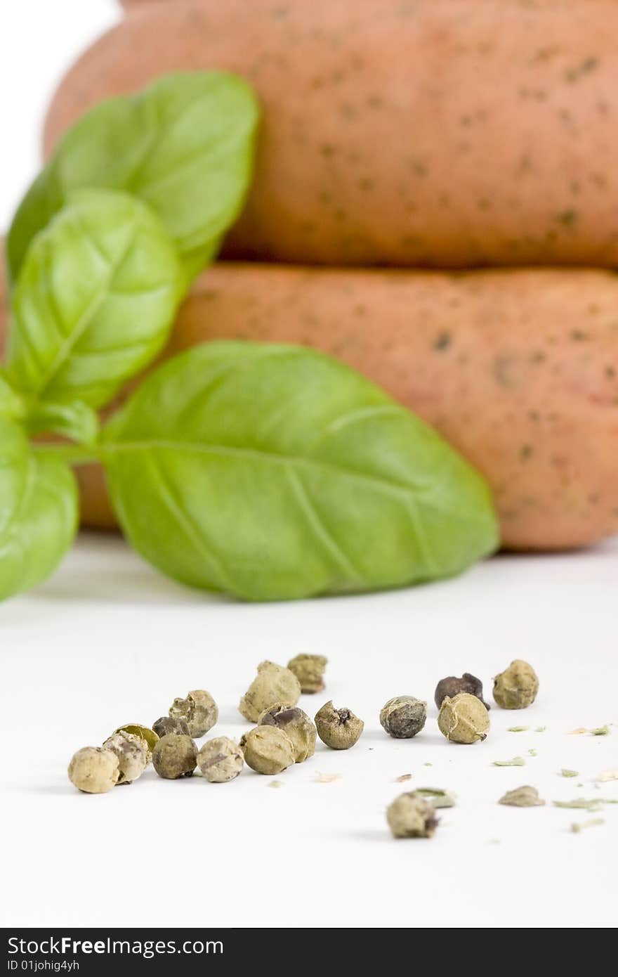 Detail of sausages with basil and green pepper