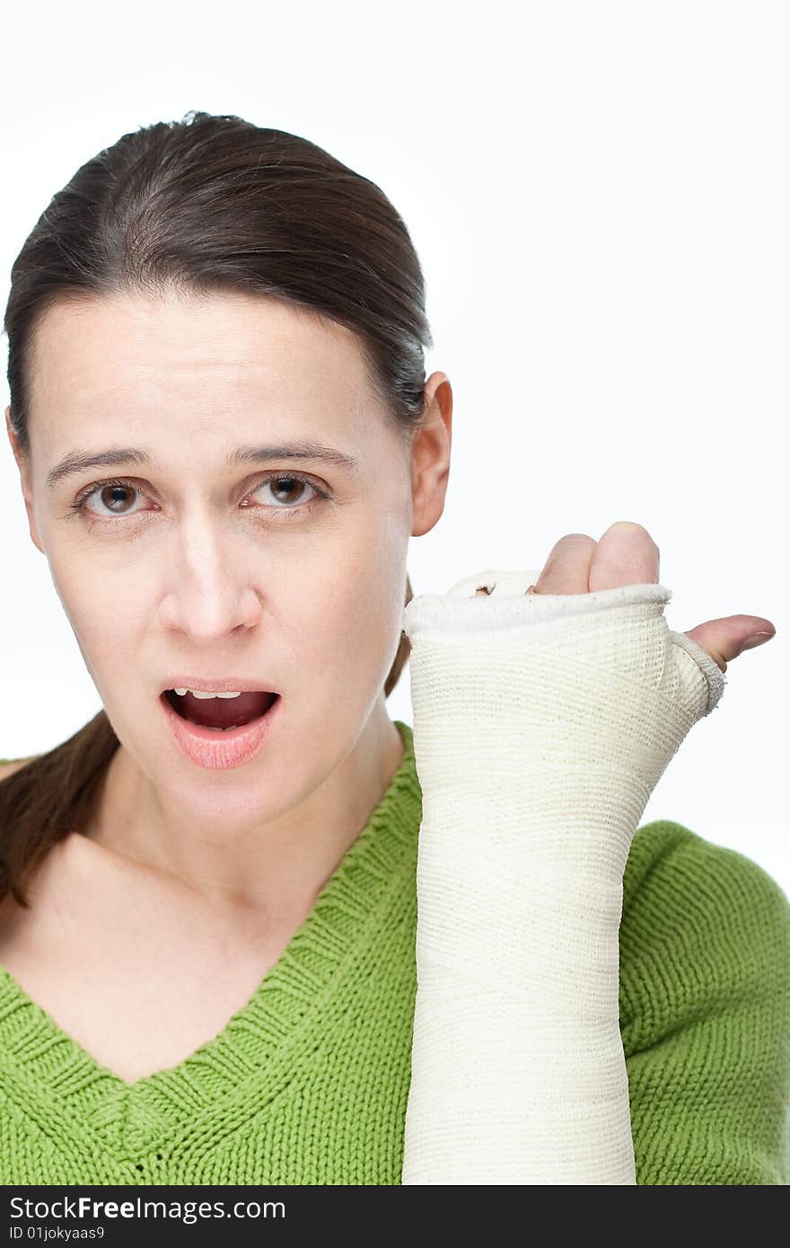 A woman with a cast on her arm on a white background. A woman with a cast on her arm on a white background