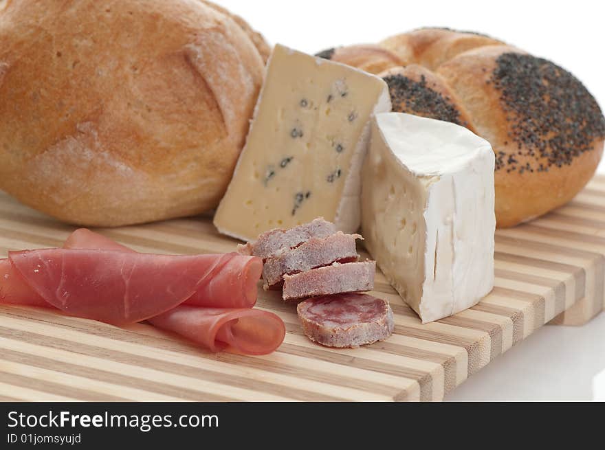 A plate with cheese and bread in front of white