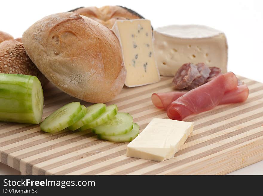 A plate with cheese and bread in front of white. A plate with cheese and bread in front of white