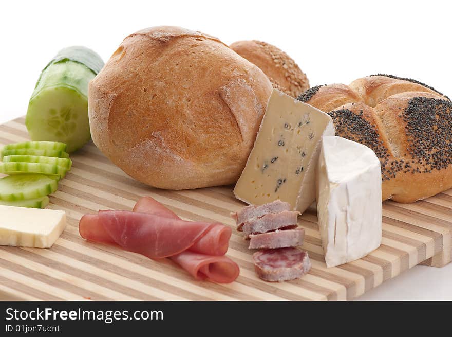 A plate with cheese and bread in front of white. A plate with cheese and bread in front of white