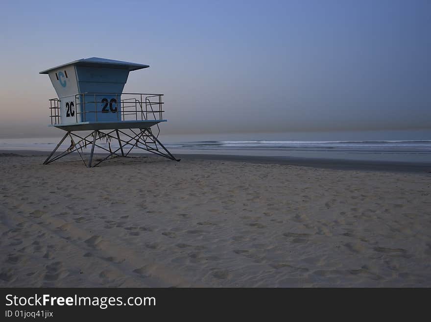 Life guard station on beach with calm ocean at sunrise with moon, San Diego, California. Life guard station on beach with calm ocean at sunrise with moon, San Diego, California