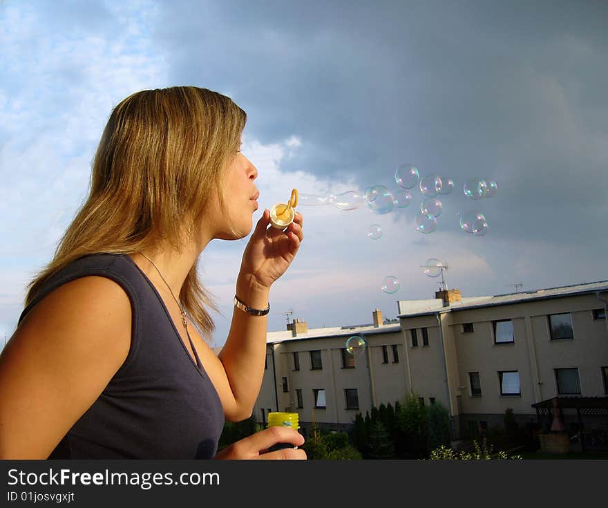 A girl blowing soap-bubbles