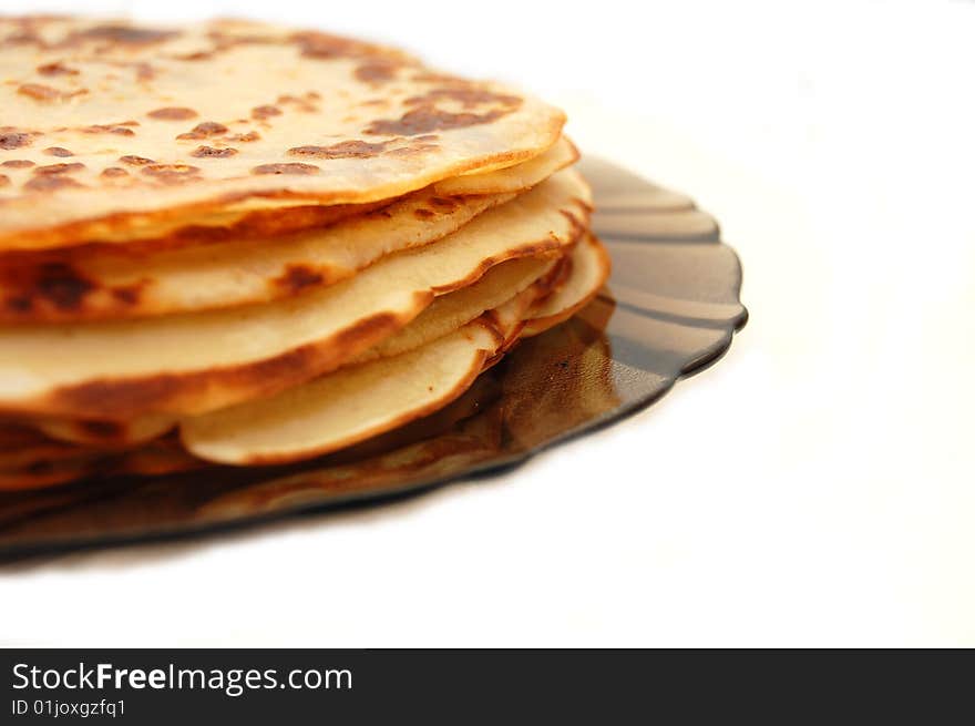 Plate with Russian pancakes on a white background