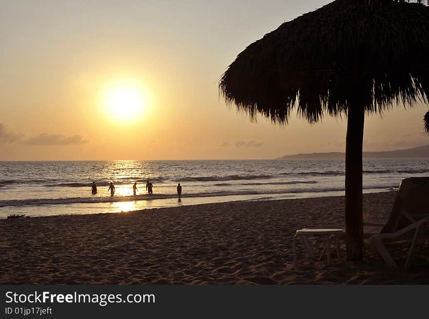 Playing in the surf at sunset on the beach in Mexico