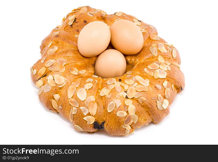 Easter pastry wreath with three brown eggs in it. Easter pastry wreath with three brown eggs in it