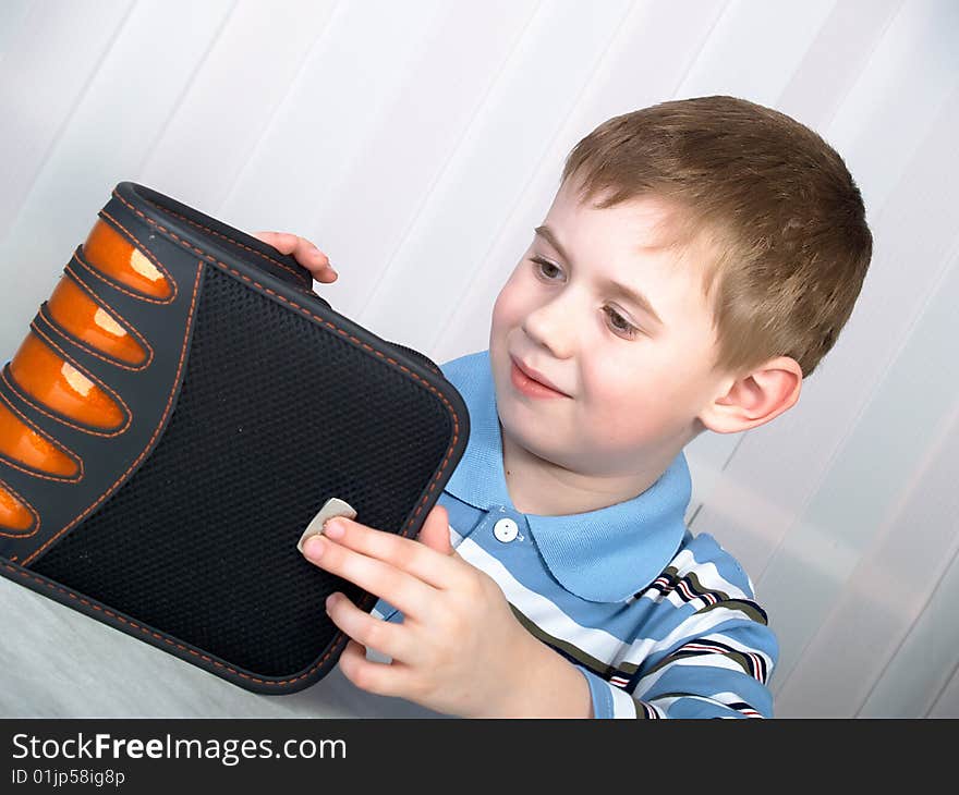 Plastic grey bag for storage DVD of disks in hands of the boy