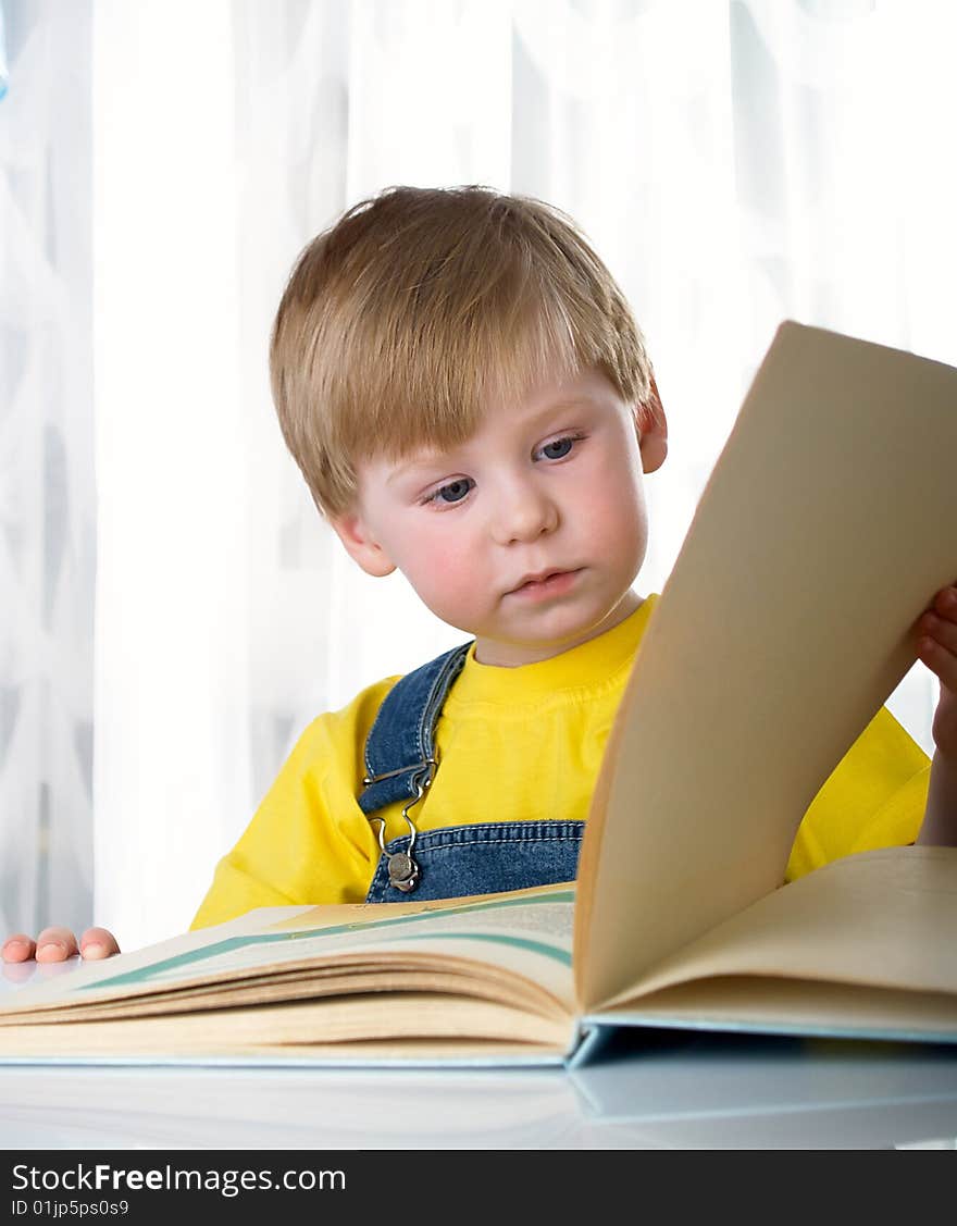 The child with books on the white background