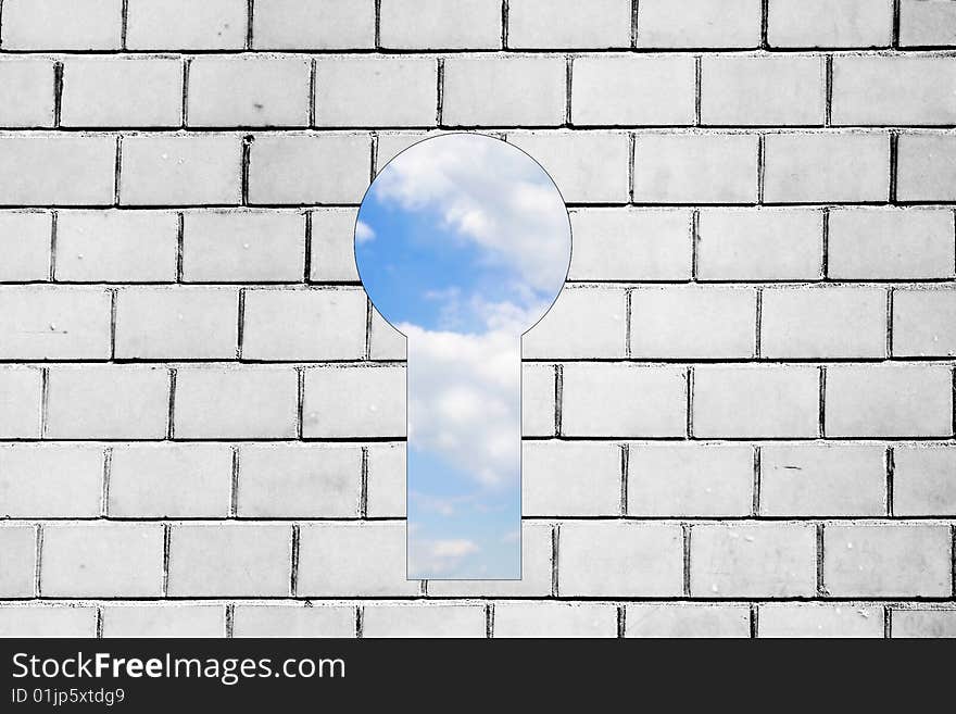 View of blue sky behind bw brick wall