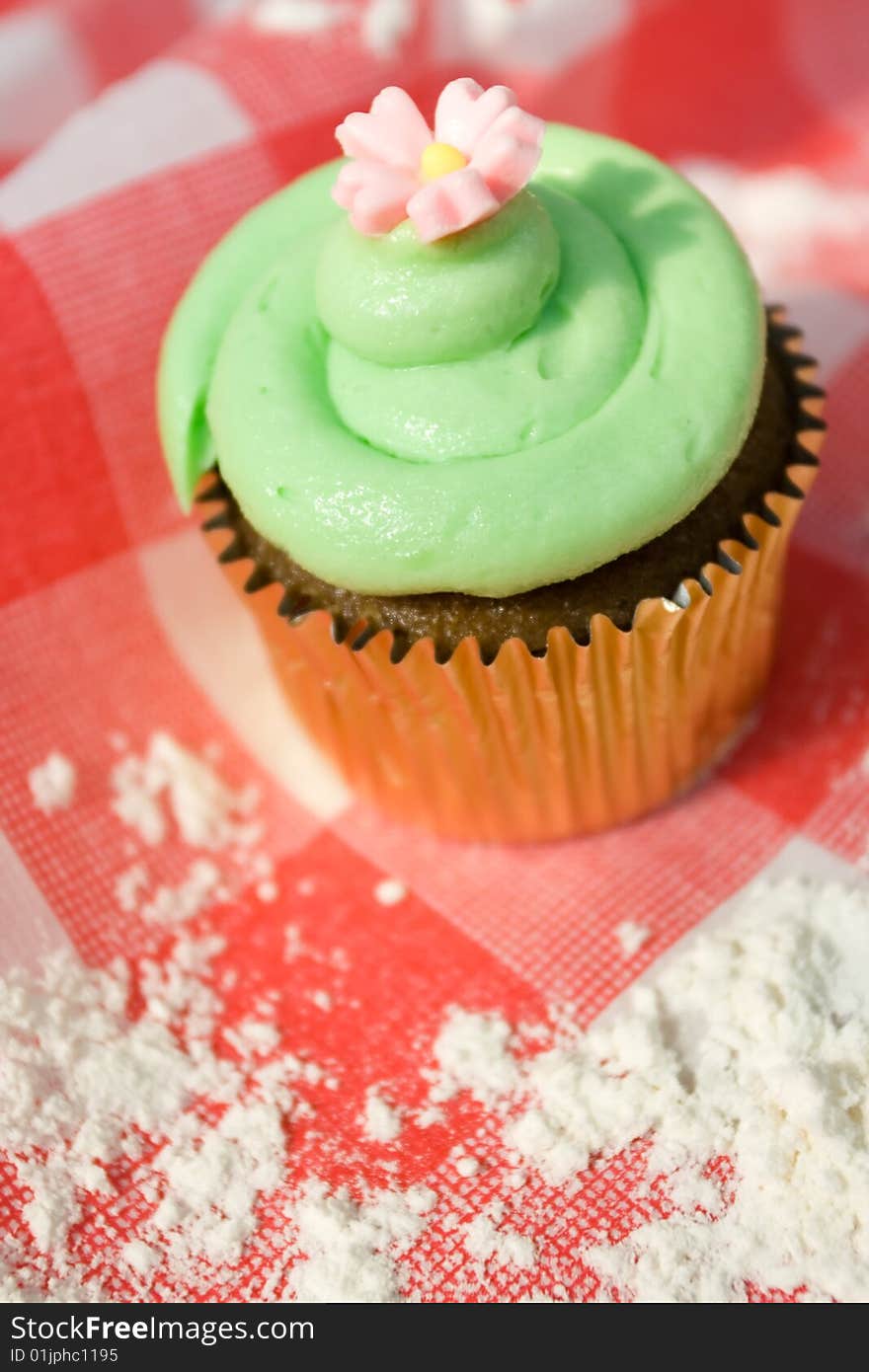 Delicious cupcake on a red table cloth. Delicious cupcake on a red table cloth