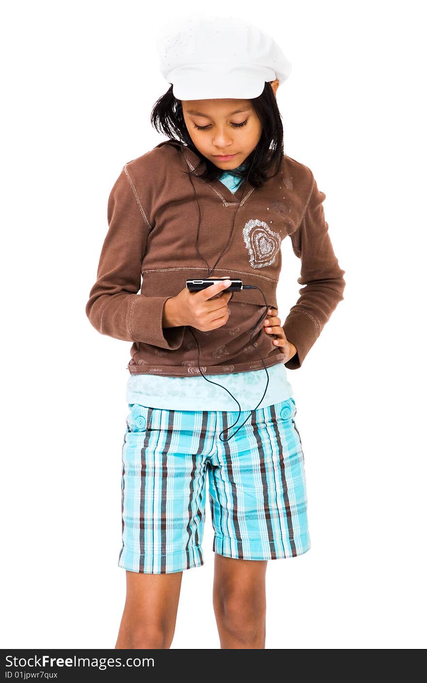 Girl listening to MP3 player with her hand on hip isolated over white. Girl listening to MP3 player with her hand on hip isolated over white