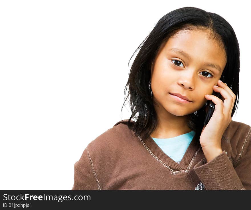 Girl talking on a mobile phone isolated over white. Girl talking on a mobile phone isolated over white