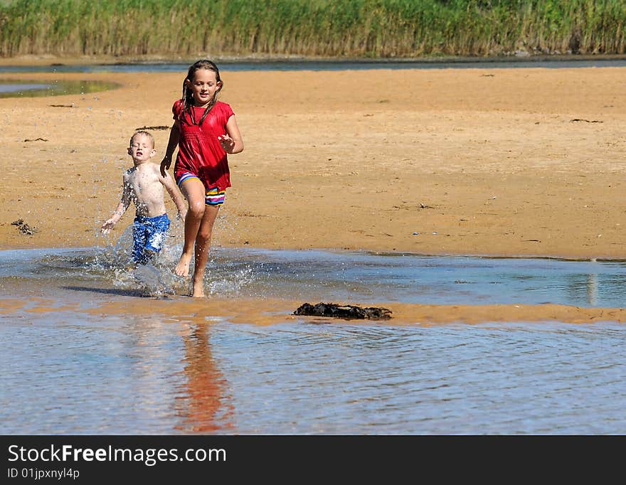 Big sister beating her smaller brother in a race. Big sister beating her smaller brother in a race