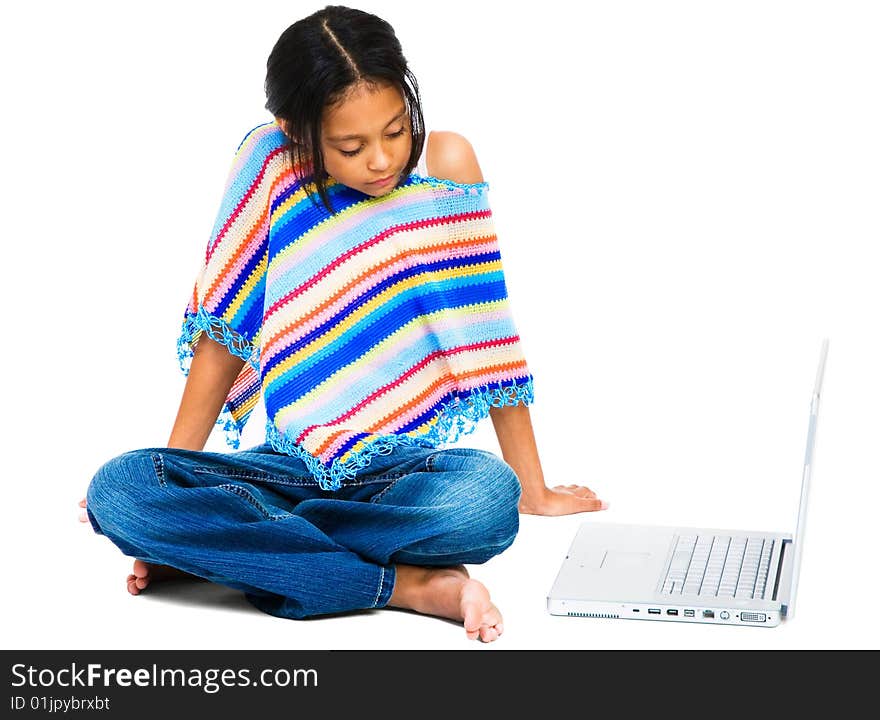 Latin American and Hispanic girl sitting near a laptop isolated over white. Latin American and Hispanic girl sitting near a laptop isolated over white